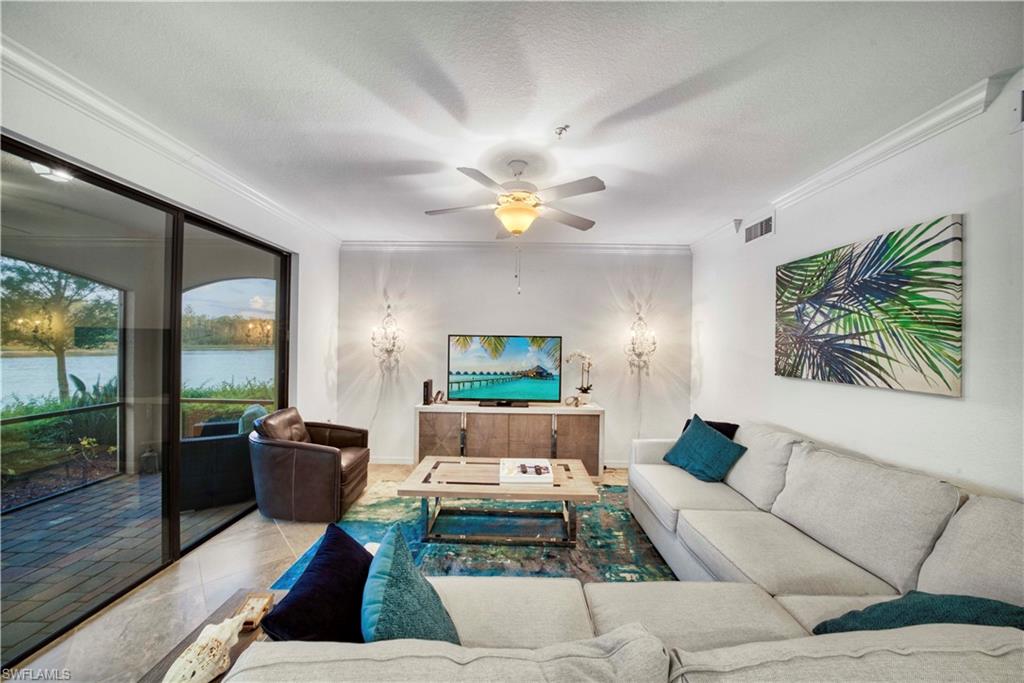 9572 Trevi Court, Unit 5017 Naples, FL 34113 - Photo 8 of 25 a living room with furniture fireplace and a large window