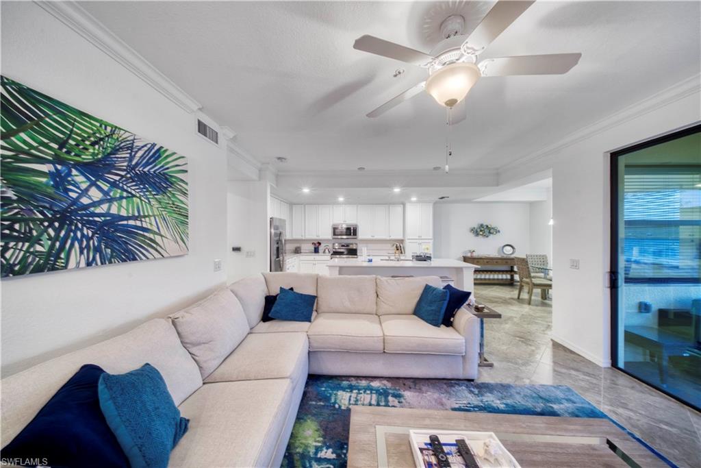 9572 Trevi Court, Unit 5017 Naples, FL 34113 - Photo 9 of 25 a living room with furniture and a fireplace