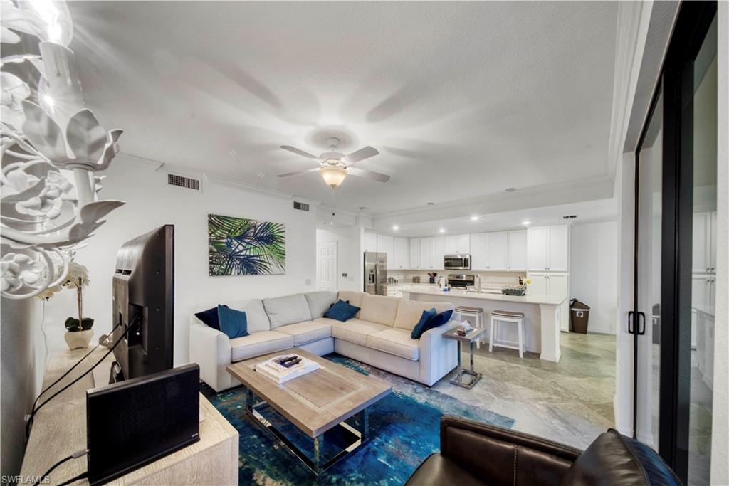 9572 Trevi Court, Unit 5017 Naples, FL 34113 - Photo 10 of 25 a living room with furniture and a fireplace