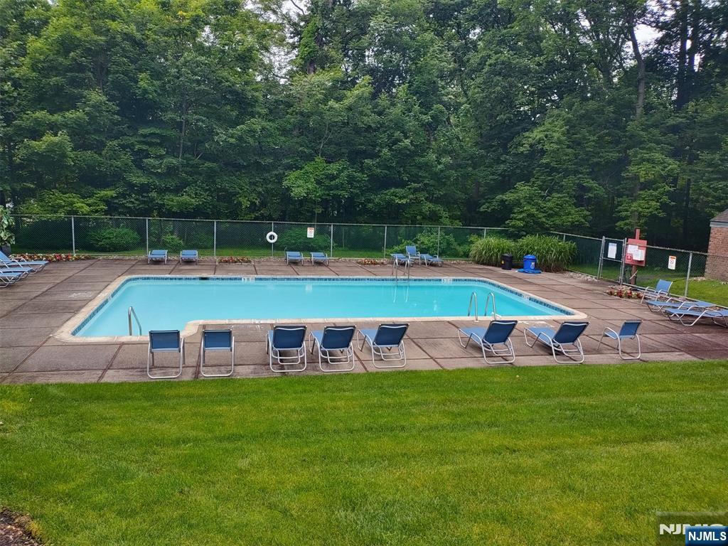2210 Hilltop Road Mahwah, NJ 07430 - Photo 14 of 14 a view of yard with swimming pool and trees in the background