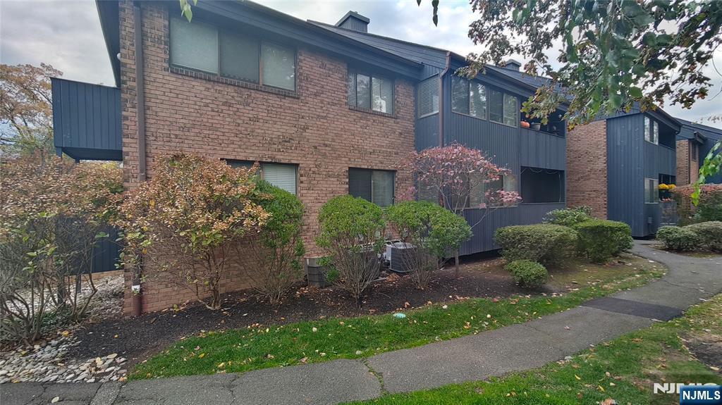 2210 Hilltop Road Mahwah, NJ 07430 - Photo 3 of 14 a view of a brick house with a yard