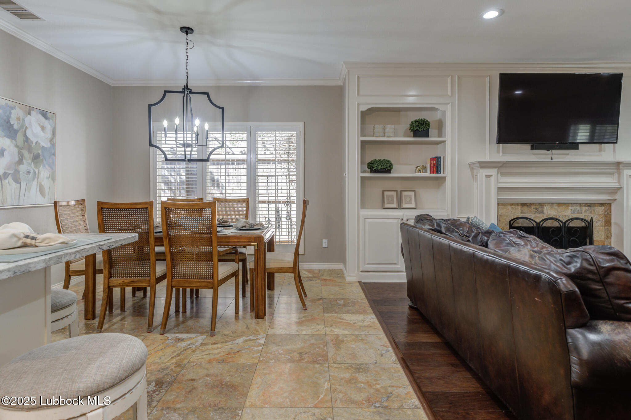 9406 Wayne Avenue Lubbock, TX 79424 - Photo 13 of 67 a view of a dining room with furniture wooden floor and chandelier