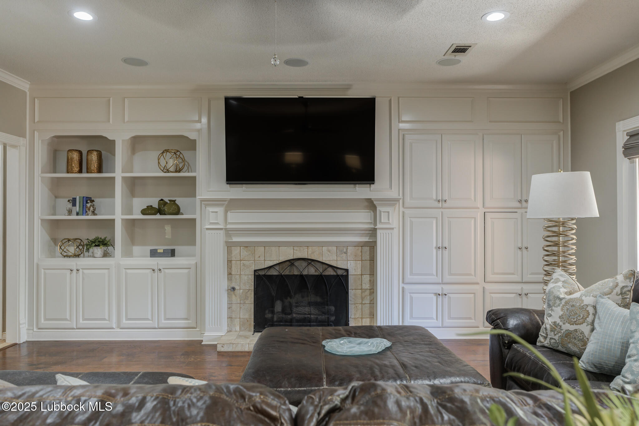 9406 Wayne Avenue Lubbock, TX 79424 - Photo 24 of 67 a living room with furniture a flat screen tv and a fireplace