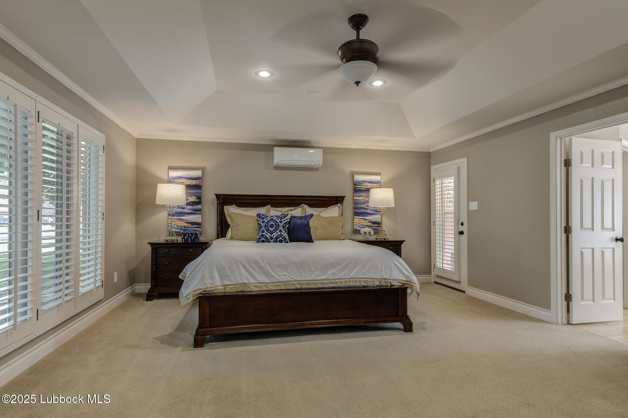 9406 Wayne Avenue Lubbock, TX 79424 - Photo 33 of 67 a spacious bedroom with a bed and a chandelier
