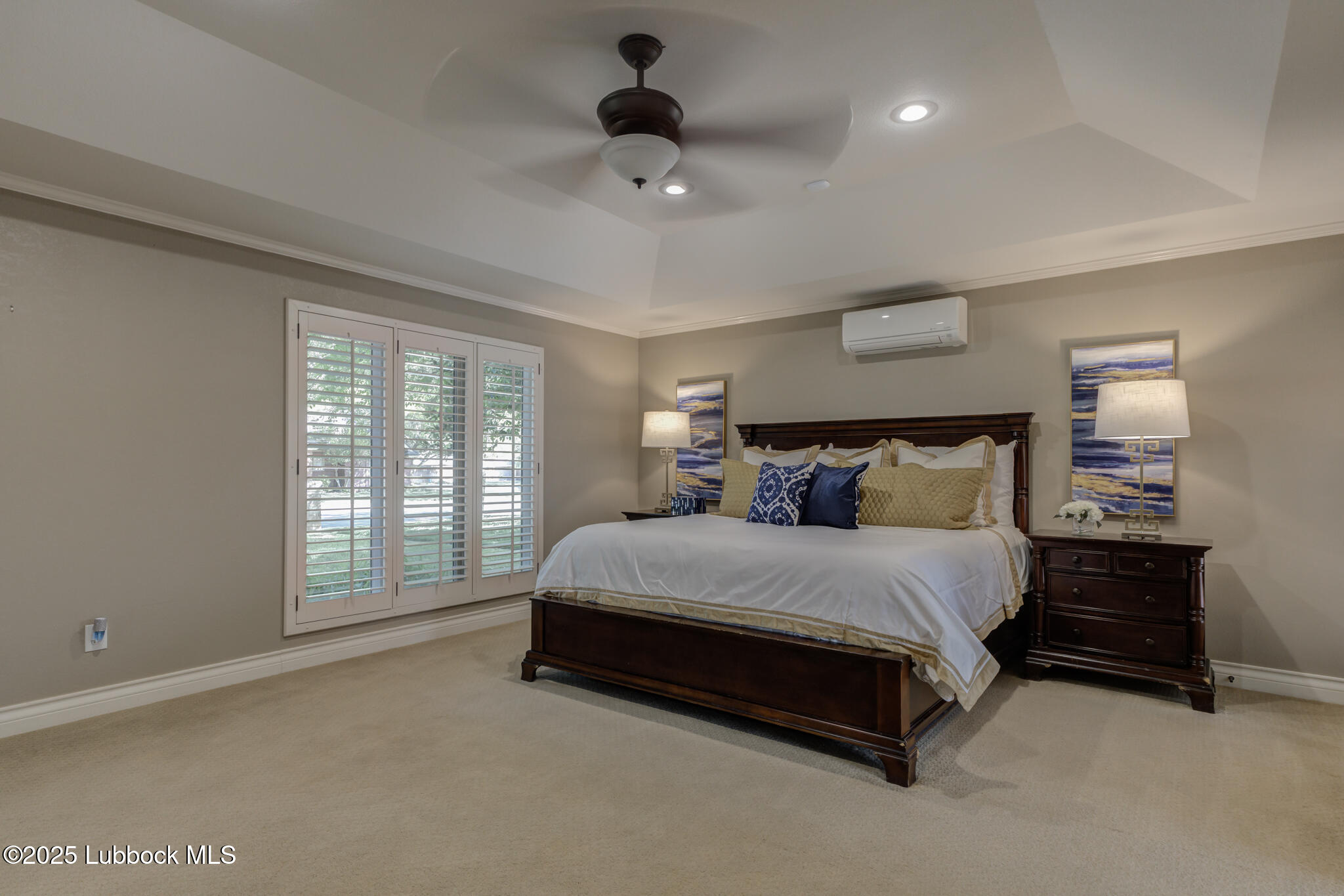 9406 Wayne Avenue Lubbock, TX 79424 - Photo 36 of 67 a spacious bedroom with a bed and a chandelier