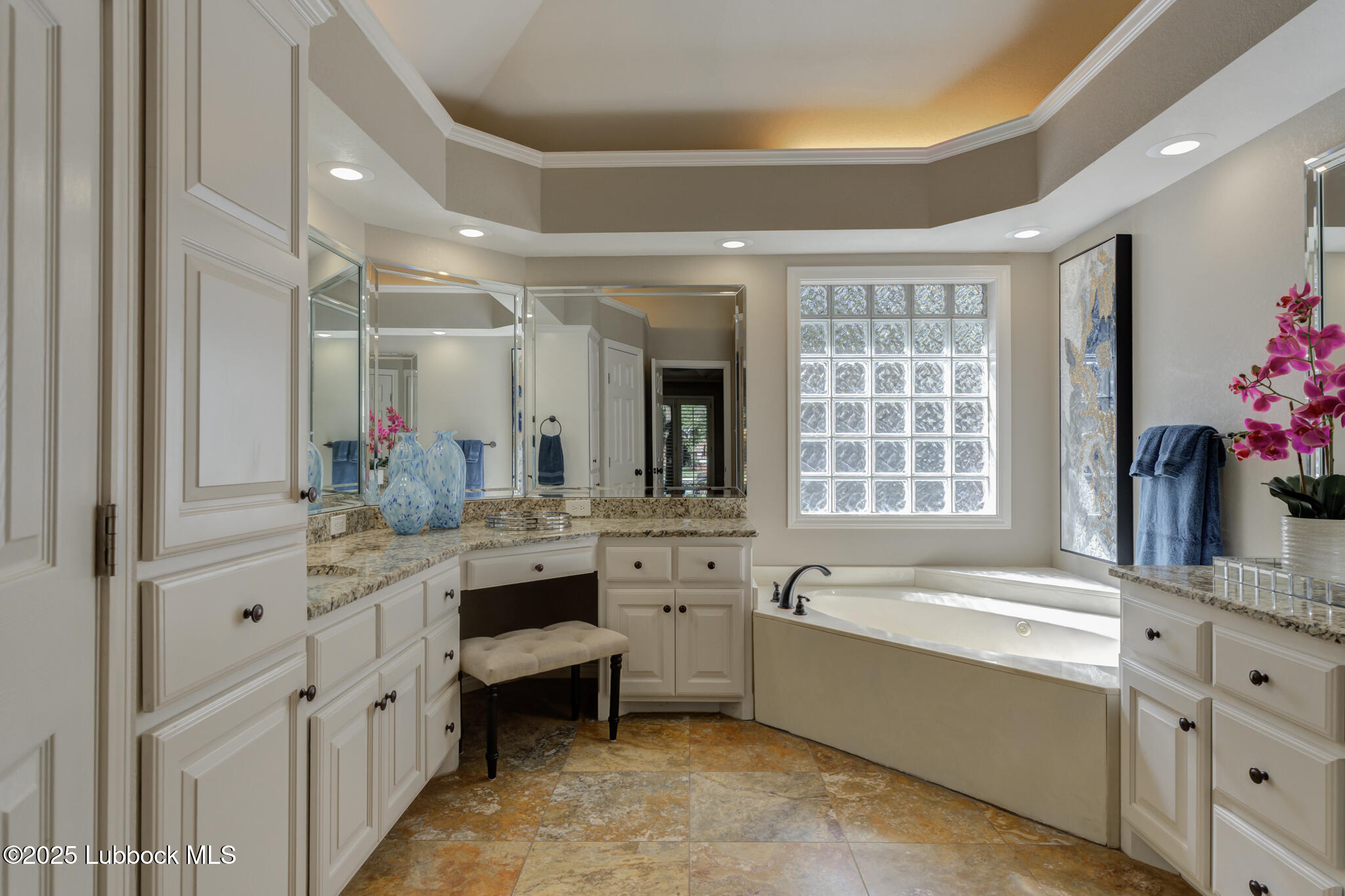 9406 Wayne Avenue Lubbock, TX 79424 - Photo 37 of 67 a large bathroom with a granite countertop tub a double vanity sink a window and a mirror