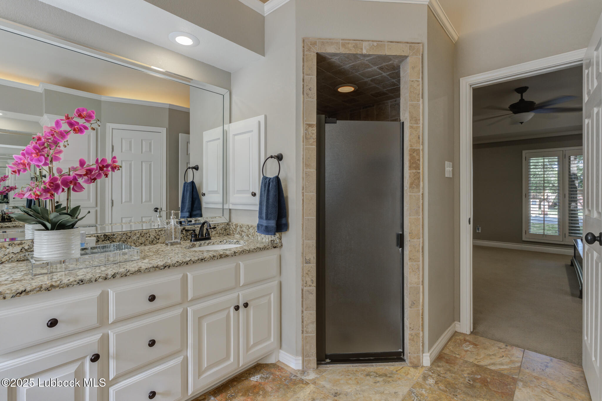 9406 Wayne Avenue Lubbock, TX 79424 - Photo 40 of 67 a bathroom with a granite countertop sink a mirror and a shower