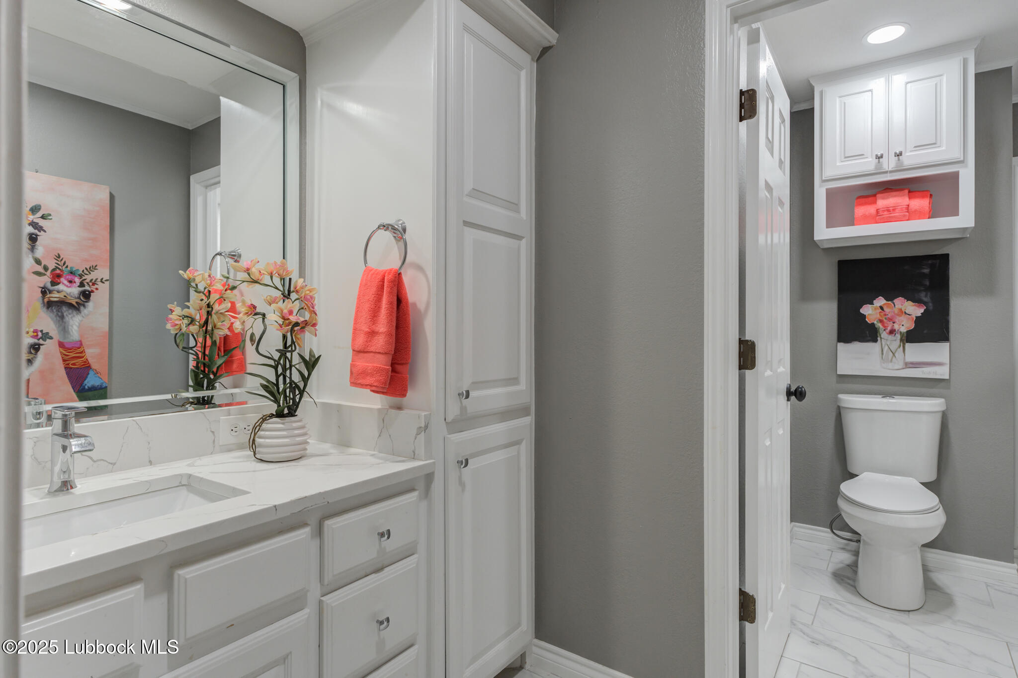 9406 Wayne Avenue Lubbock, TX 79424 - Photo 53 of 67 a bathroom with a sink a toilet and a large mirror