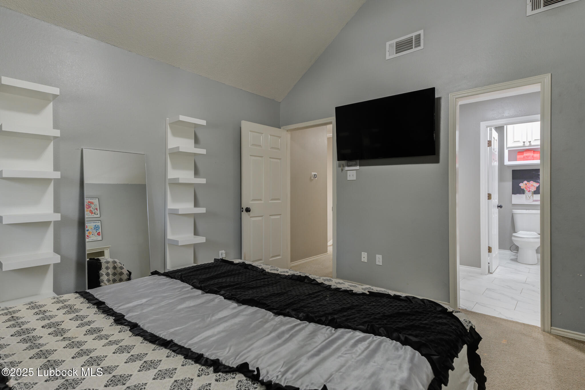 9406 Wayne Avenue Lubbock, TX 79424 - Photo 54 of 67 a bedroom with a bed and a flat screen tv
