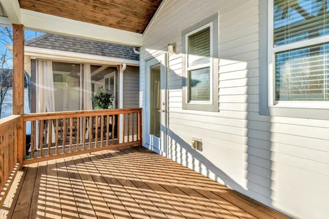 a bathroom with a granite countertop sink a mirror and shower