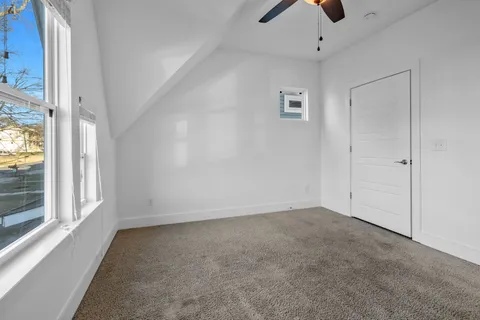 a view of a room with a wooden door