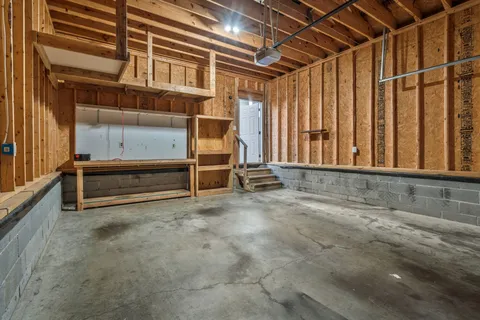 a view of a house with a small yard and wooden fence