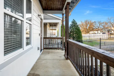 a view of a hallway with wooden floor and a living room