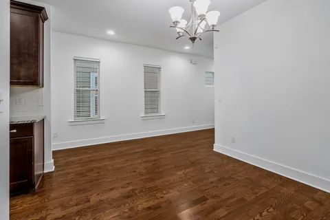 a kitchen with granite countertop stainless steel appliances a sink stove and refrigerator