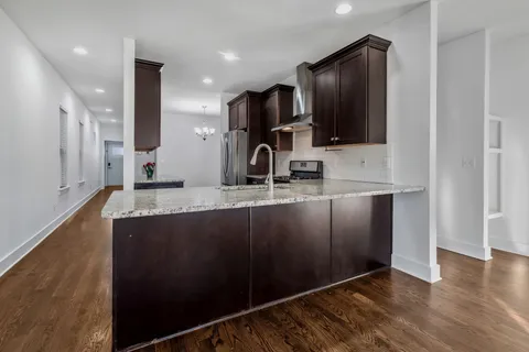 a kitchen with granite countertop a stove and a sink