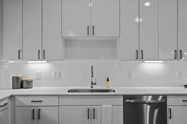 a kitchen with a sink and cabinets