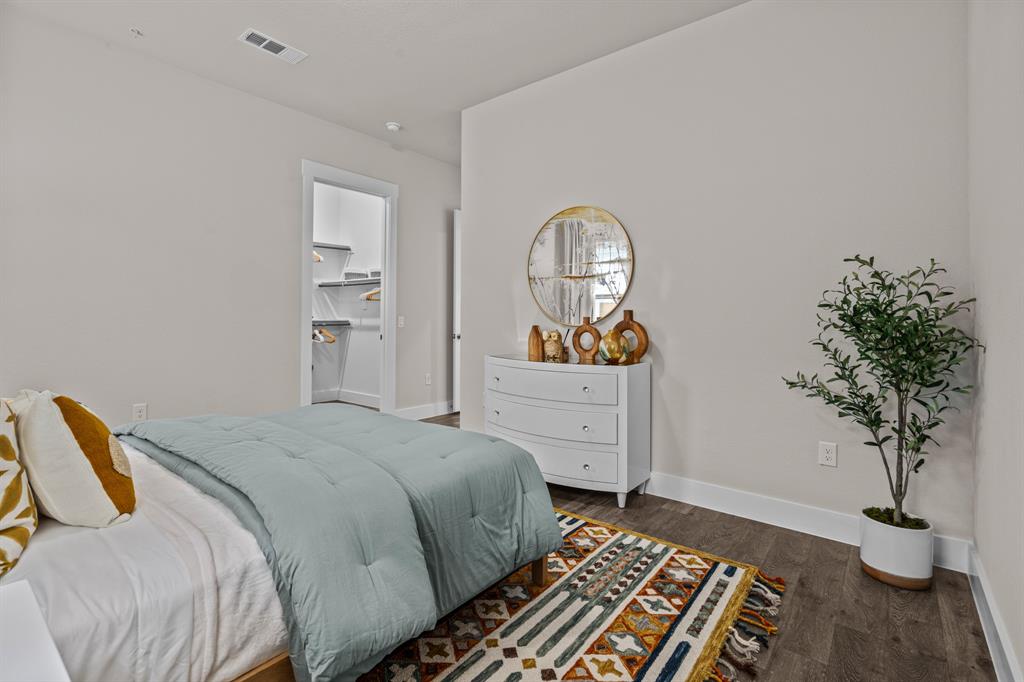 3277 Ganzer Road West, Unit 223A Denton, TX 76207 - Photo 19 of 32 a bedroom with a bed and a potted plant