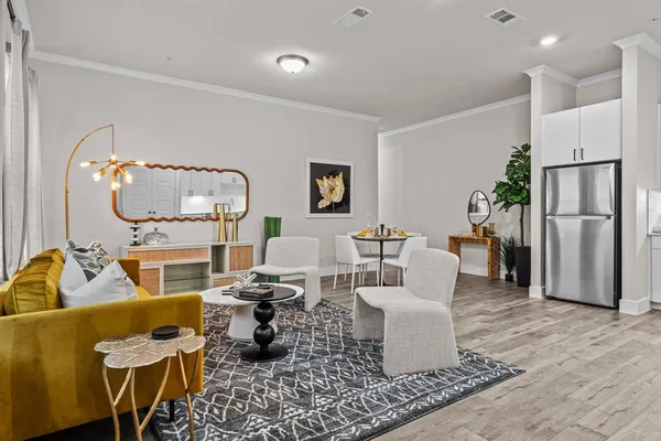 a living room with furniture and a mirror
