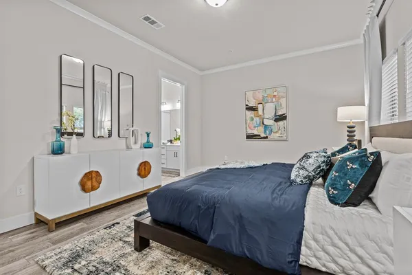 a bedroom with a bed and a dresser