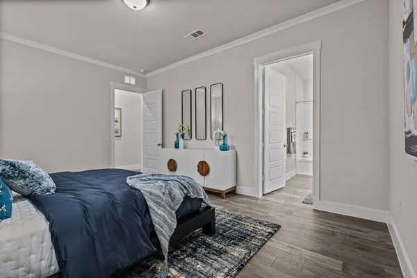 a bedroom with a large bed and a window