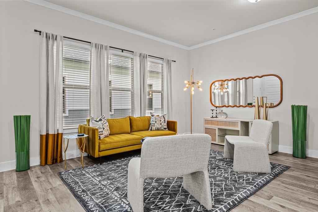 3277 Ganzer Road West, Unit 223A Denton, TX 76207 - Photo 3 of 32 a living room with furniture and a rug