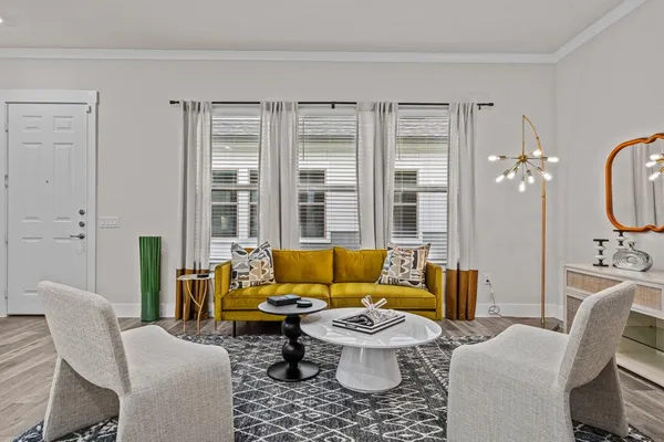 a living room with furniture and a large window