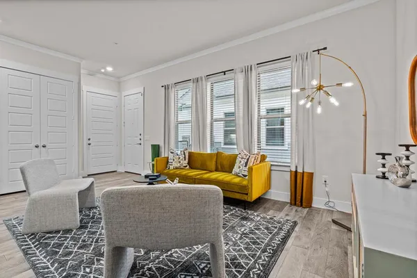 a living room with furniture and wooden floor