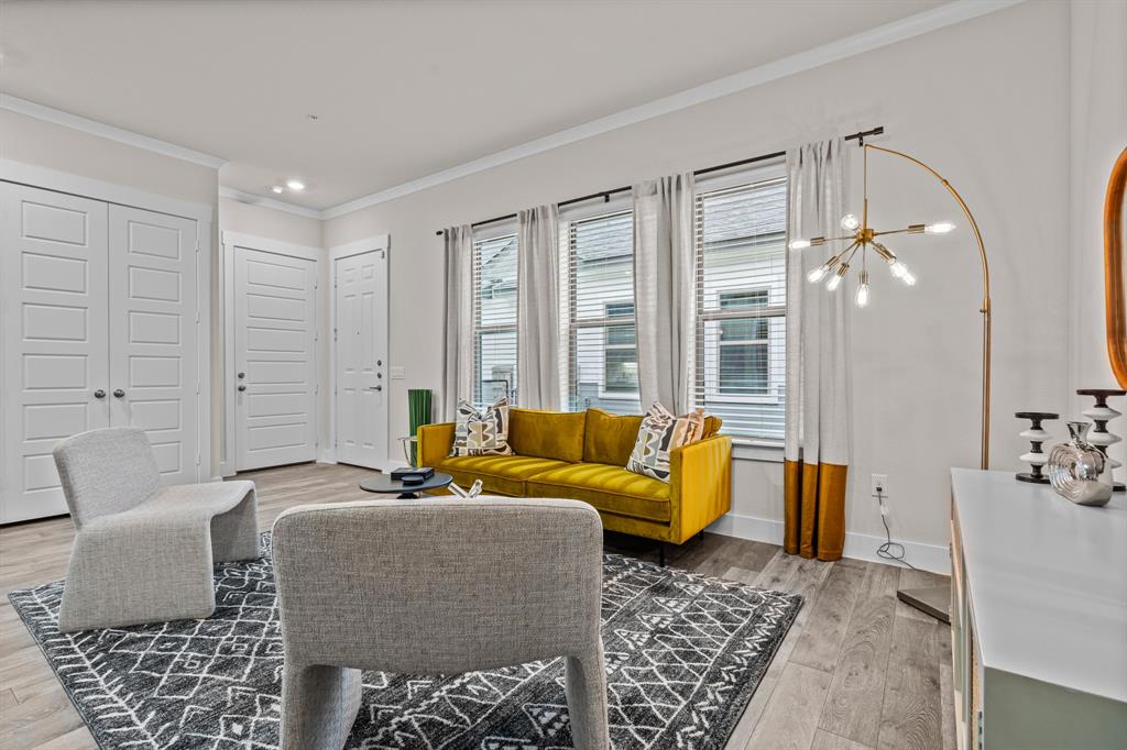 3277 Ganzer Road West, Unit 223A Denton, TX 76207 - Photo 5 of 32 a living room with furniture and wooden floor