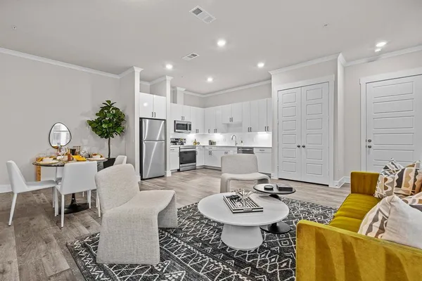 a living room with furniture and kitchen view