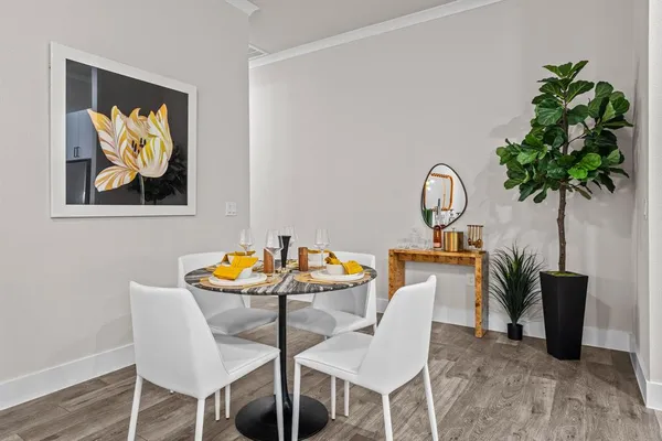 a dining room with furniture and a potted plant