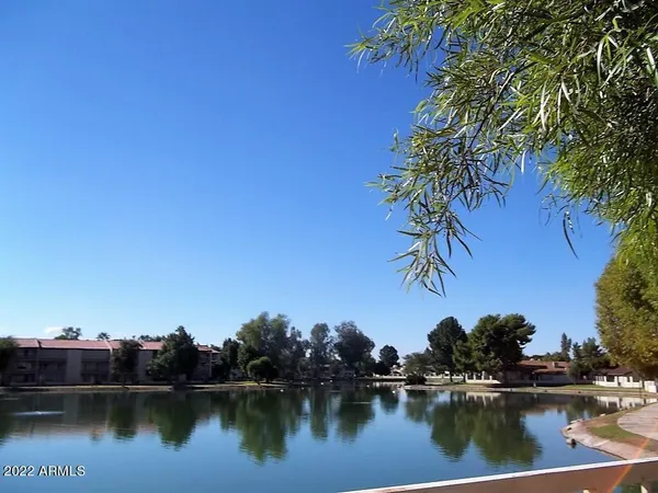 a view of a lake with houses in the back