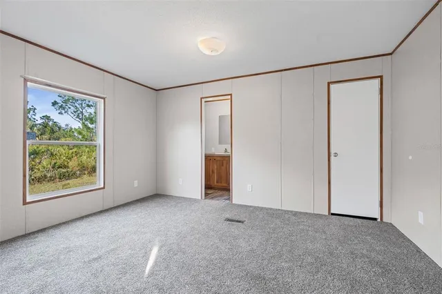 an empty room with windows and closet