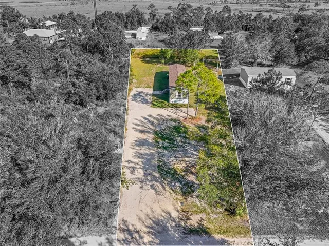 a view of a lake with large trees