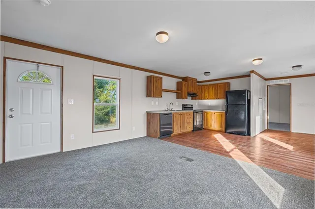 a view of a kitchen with a sink hardwood floor and a kitchen