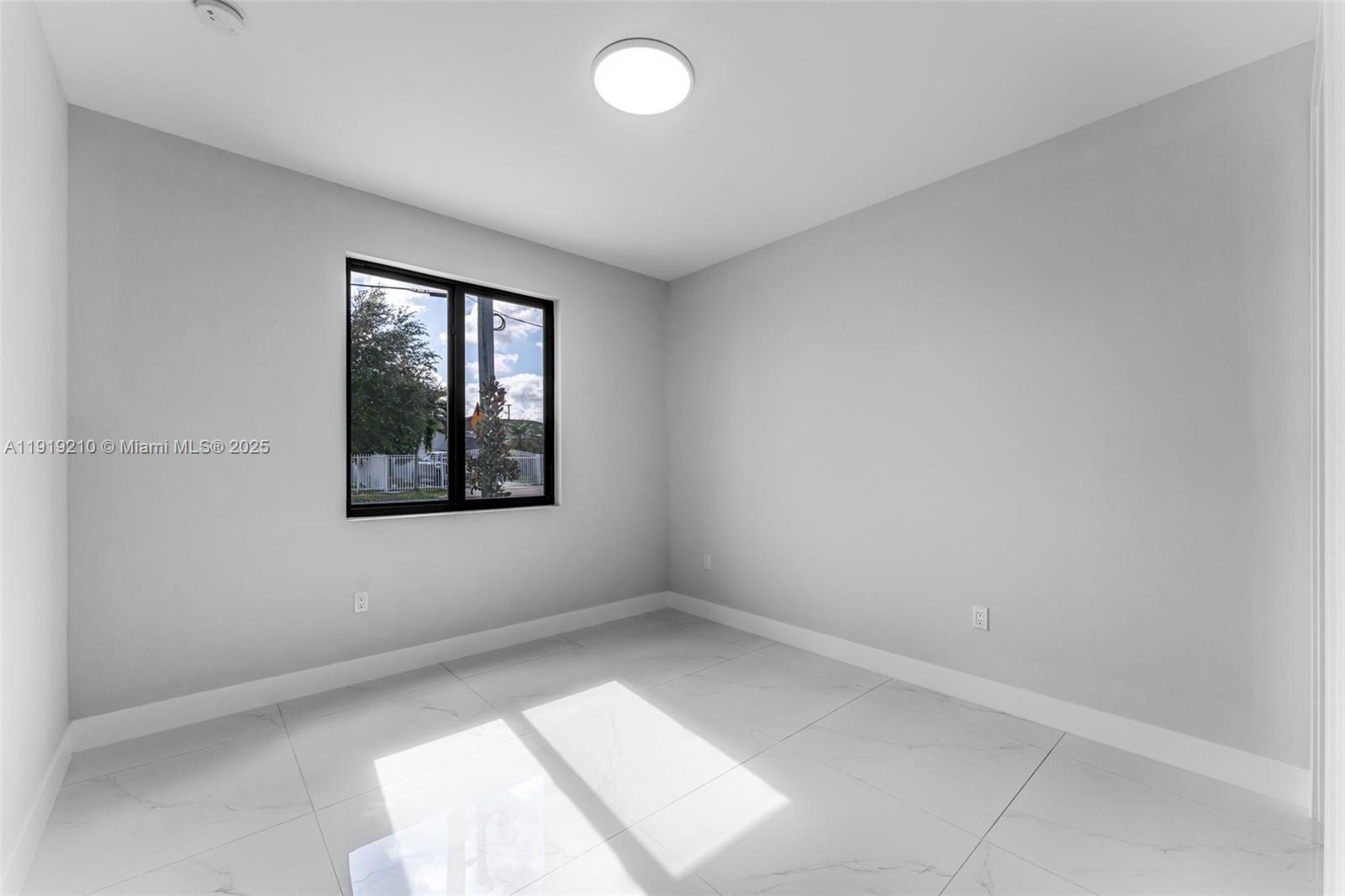 12383 Southwest 220th Street Miami, FL 33170 - Photo 12 of 20 an empty room with windows