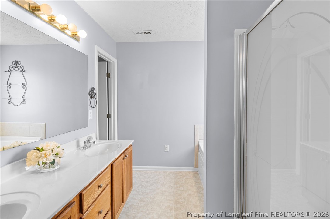 28 Coyt Circle Spring Lake, NC 28390 - Photo 20 of 41 a bathroom with a sink and a mirror