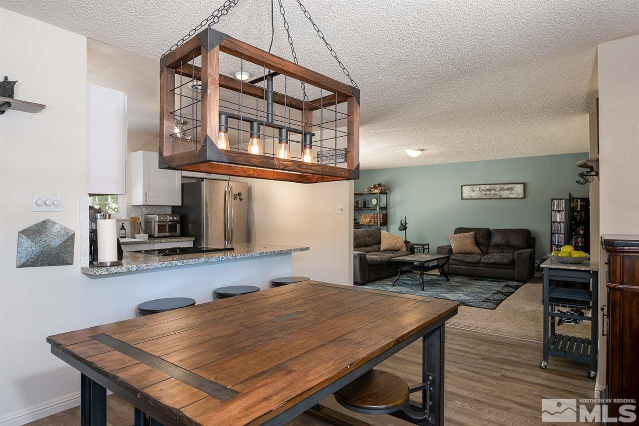 3425 Pierremont Road Reno, NV 89503 - Photo 15 of 28 a living room with furniture a flat screen tv and kitchen view