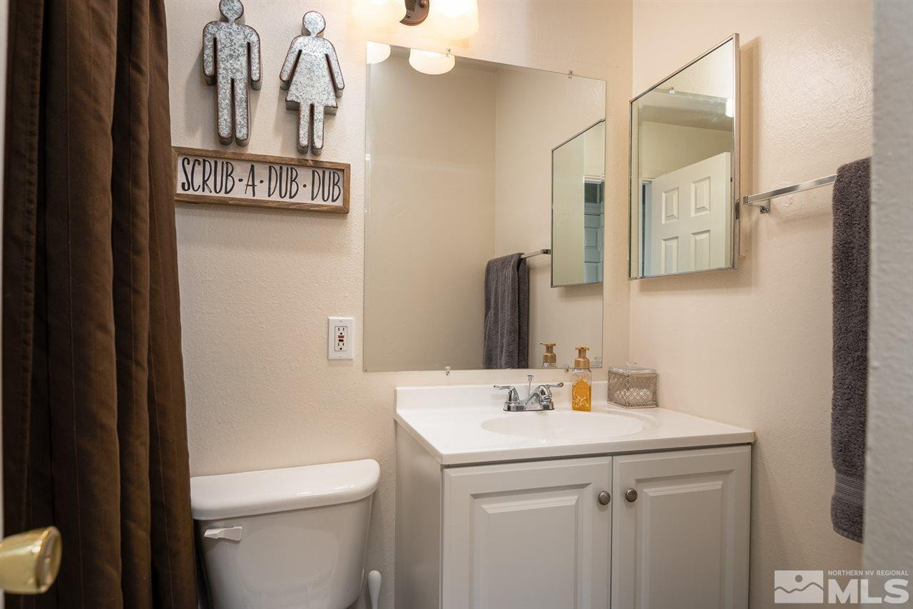 3425 Pierremont Road Reno, NV 89503 - Photo 21 of 28 a bathroom with a sink a toilet and mirror