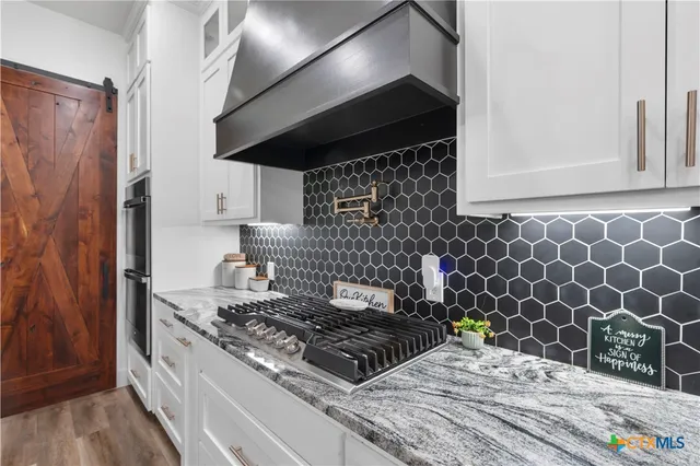 a kitchen with a stove and a cabinets