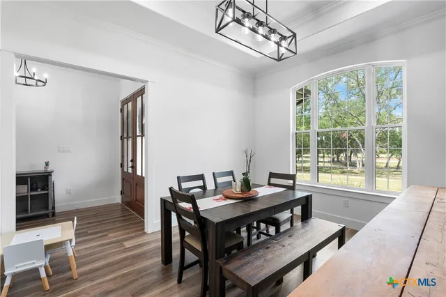 a living room with furniture a table and a large window