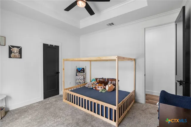 a bedroom with furniture and baby crib
