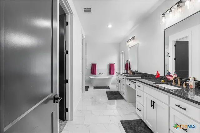 a kitchen with cabinets a sink and appliances
