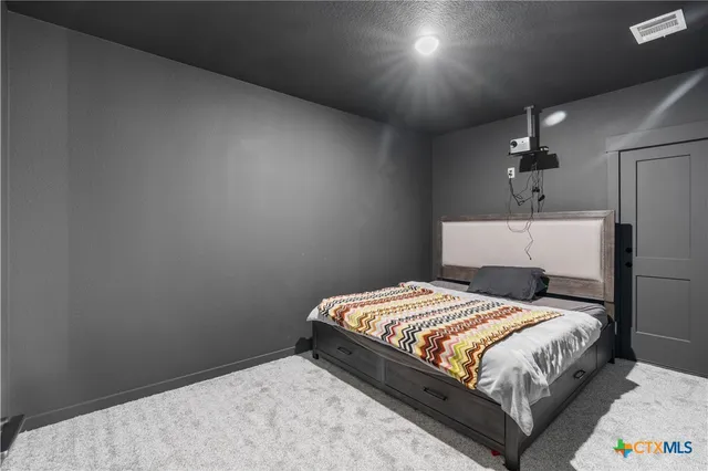 a bedroom with a bed and a table