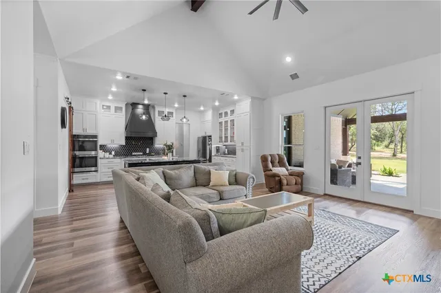 a living room with furniture and kitchen view
