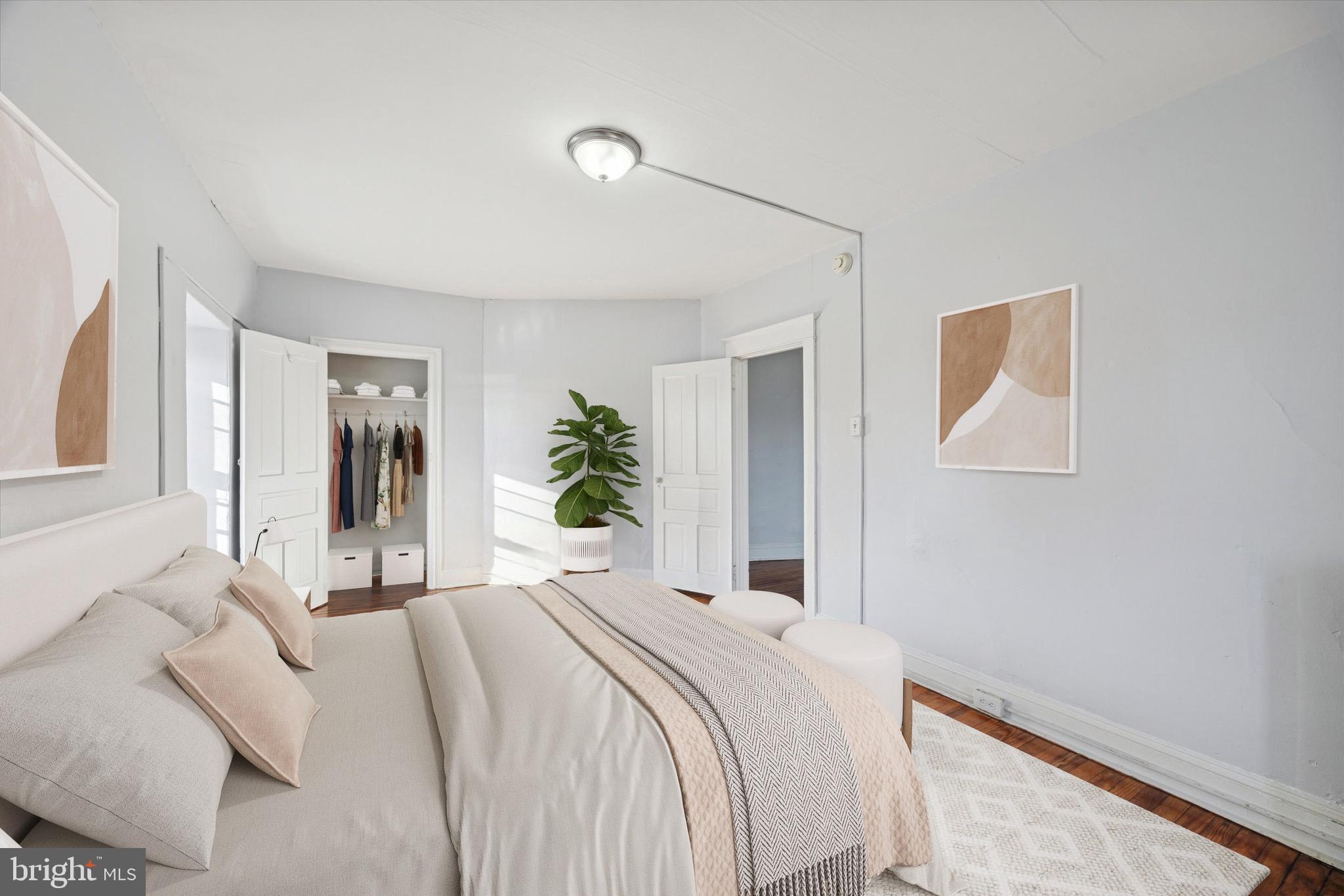 a bedroom with a bed and a painting on the wall