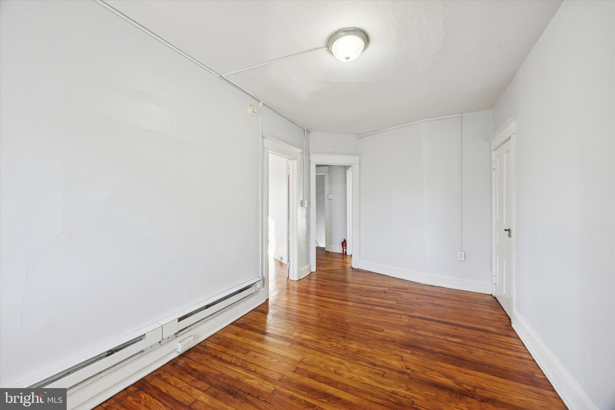 330 Kerlin Street, Unit 3 Chester, PA 19013 - Photo 3 of 15 a view of an empty room and wooden floor