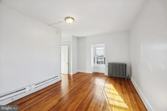 a view of wooden floor and windows in a room