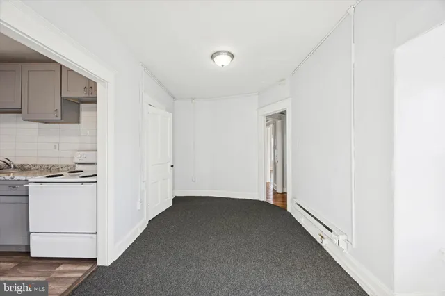 a view of a kitchen with a sink and refrigerator