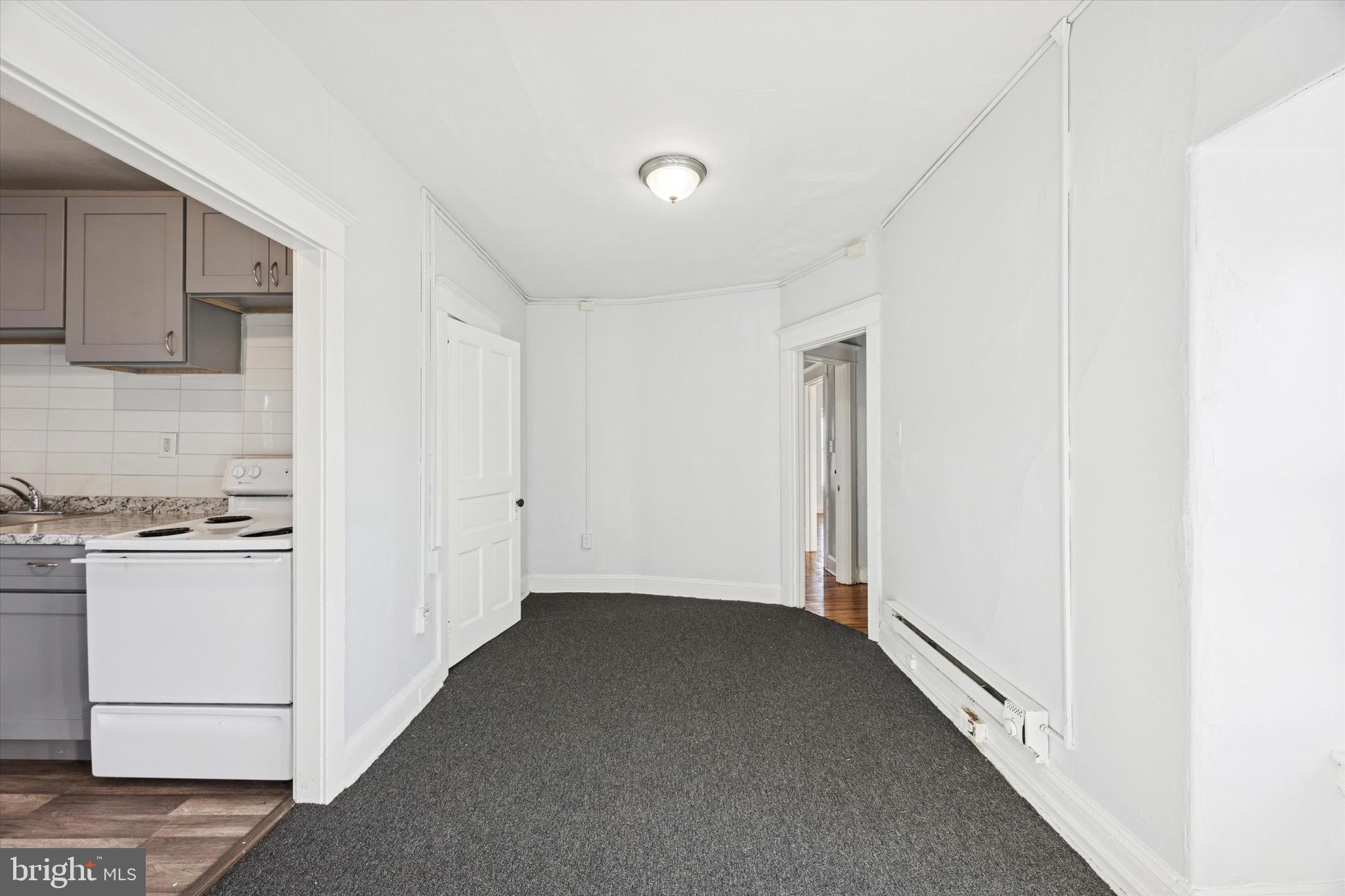 330 Kerlin Street, Unit 3 Chester, PA 19013 - Photo 9 of 15 a view of a kitchen with a sink and refrigerator