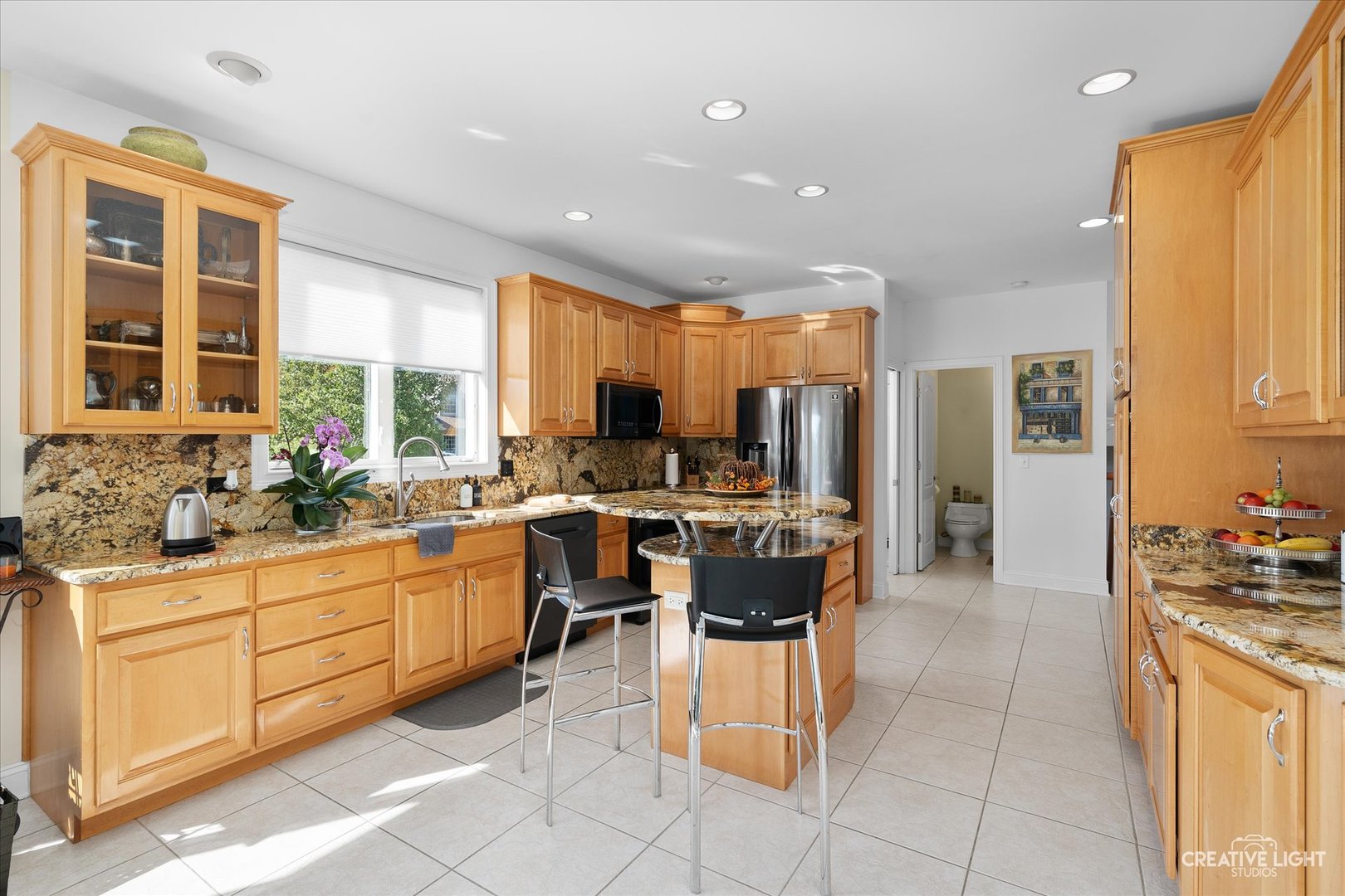 3912 Highknob Circle Naperville, IL 60564 - Photo 11 of 42 a kitchen with stainless steel appliances kitchen island granite countertop a sink and cabinets